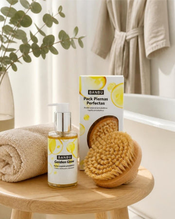 Aceite corporal Golden Glow y pack piernas perfectas de BANBU sobre un taburete de madera